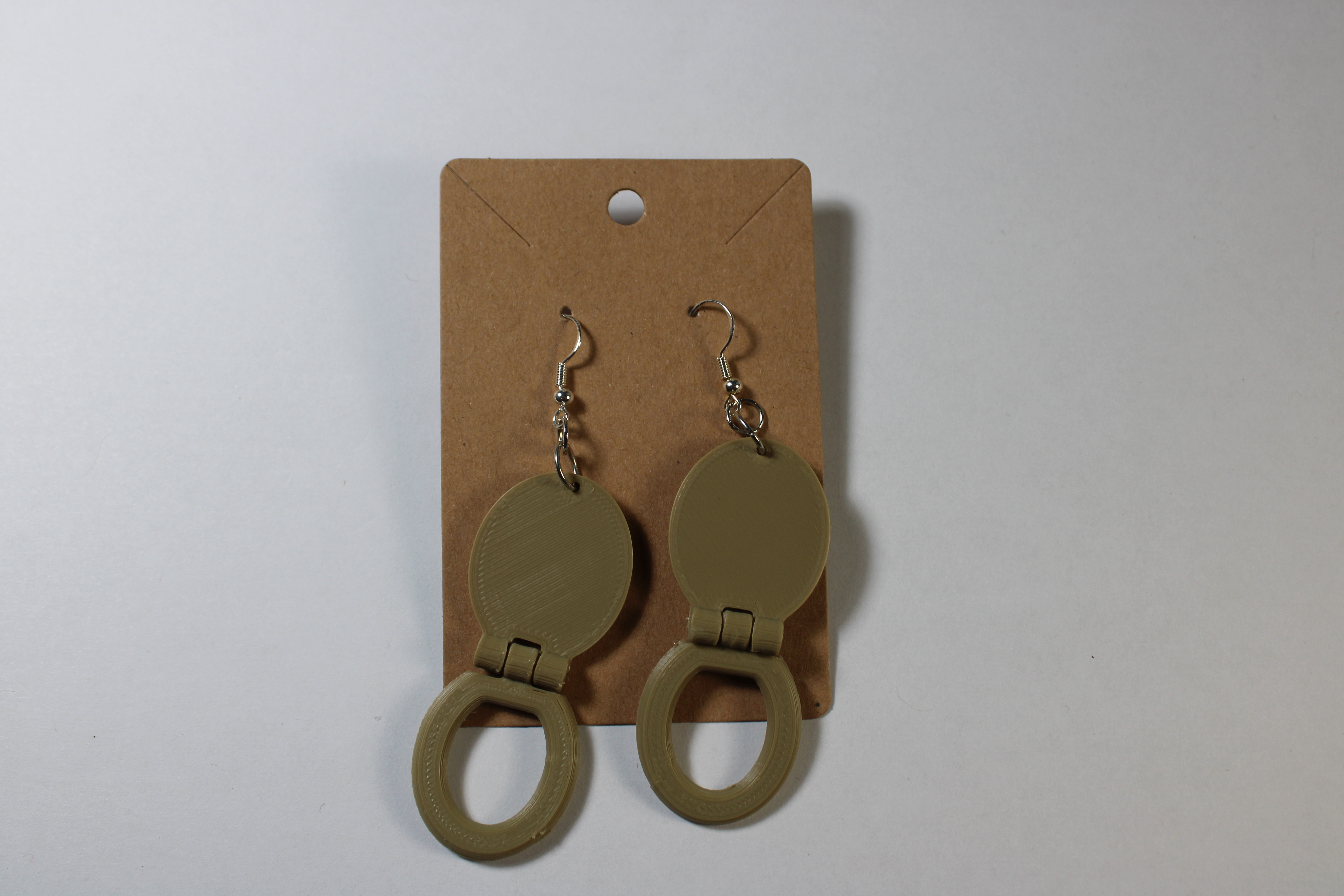 Two Wood Toilet Seat Earrings on display card