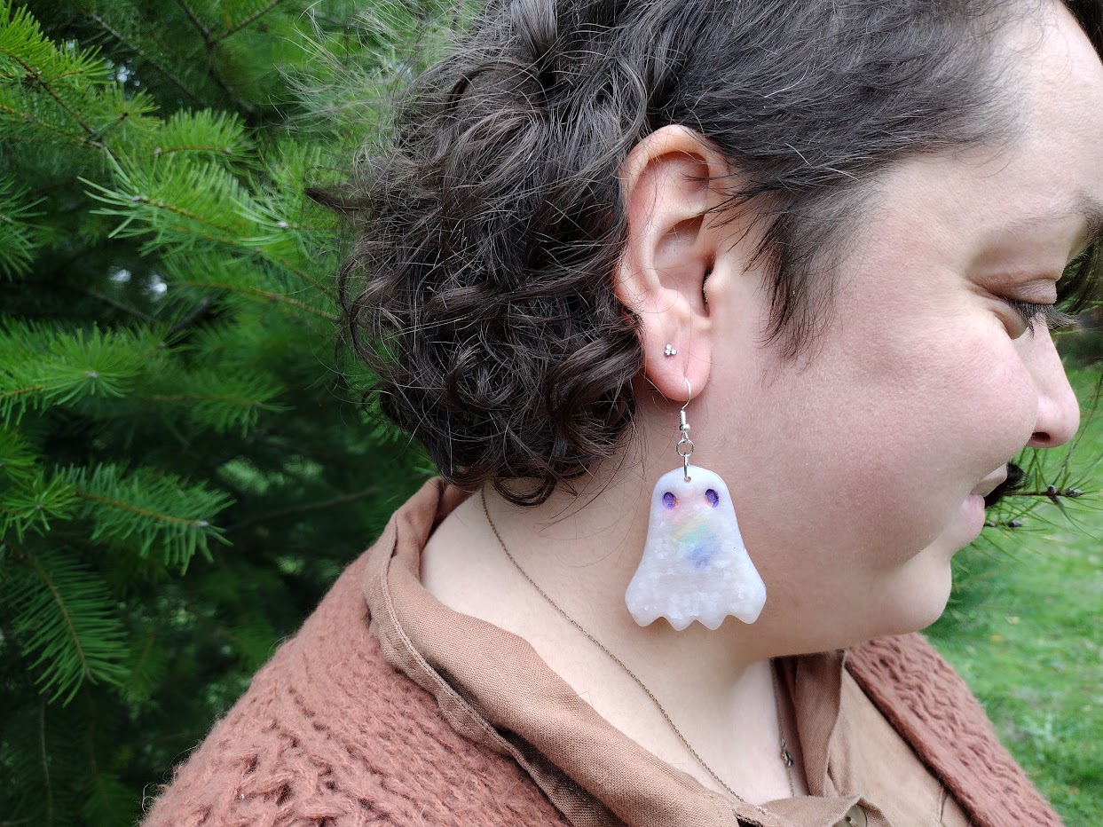 Woman wearing Pride Ghost Earrings - Rainbow