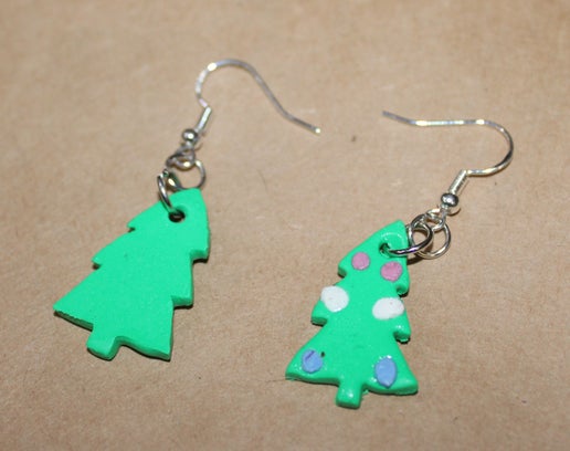 Tree earring with colored ornaments in pink, white, and baby blue from top to bottom