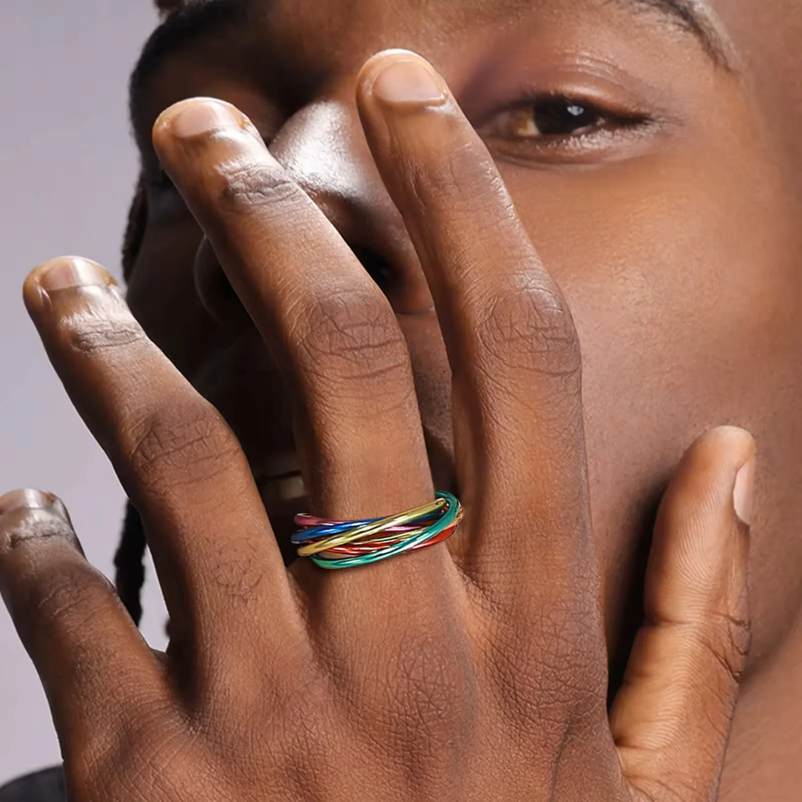 Rainbow Fidget Ring on a hand, by a face
