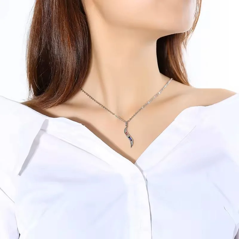 S Pendant with Rainbow Rhinestones on person